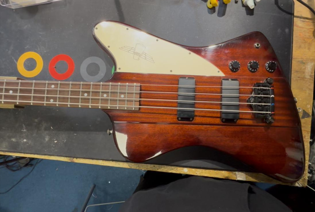 Wood-finished bass guitar on the workbench
